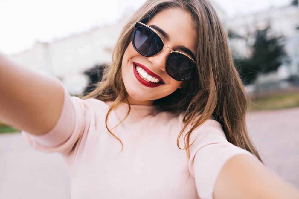 Brown haired woman with sunglasses smiling, hutnsville al
