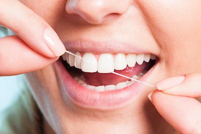 woman flossing in Huntsville, Al