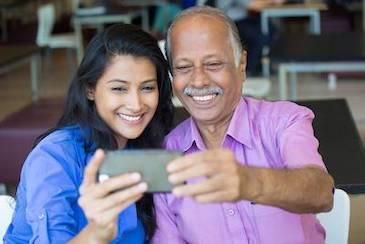 A father and daughter smiling for a photo