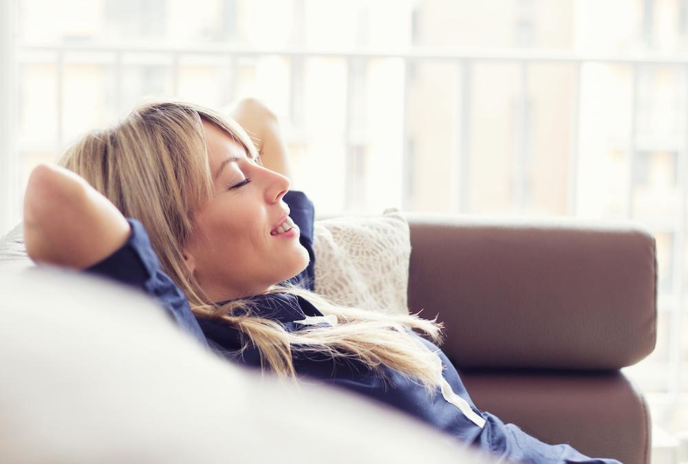 Woman relaxing on couch smiling, huntsville al