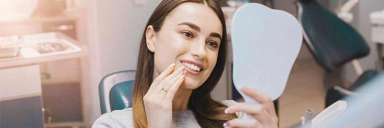 Woman looking at her whitened teeth