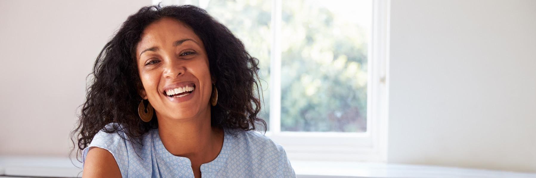 Woman smiling in brightly lit room