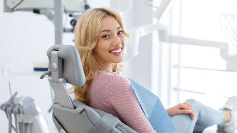 woman sitting in exa chair | root canal huntsville al