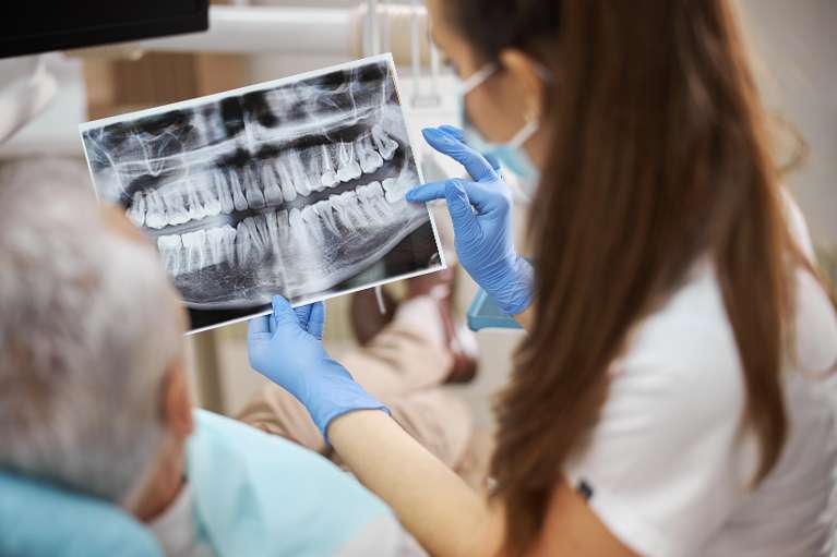 Woman dentist showing patient his x-rays, huntsville al
