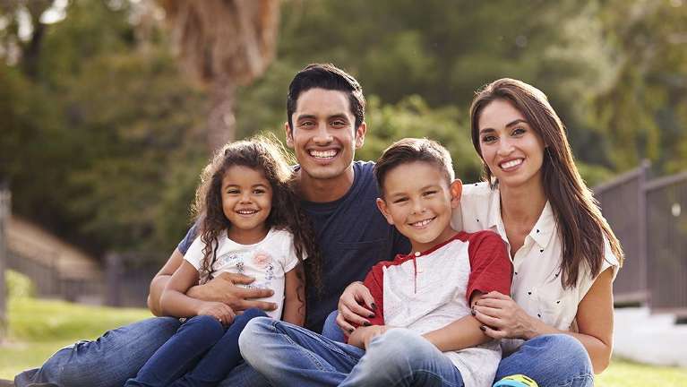 Family smiling in the park | Family Dentist Huntsville