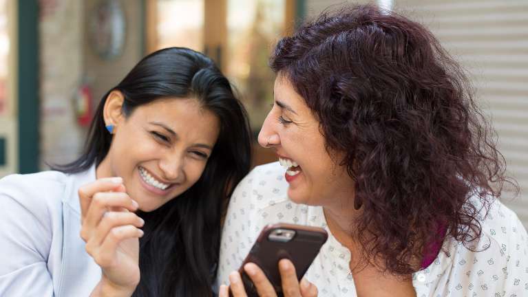 Two friends laughing | missing teeth in Huntsville