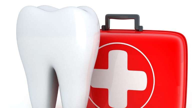 Image of non real tooth standing next to a first aid kit, huntsville AL
