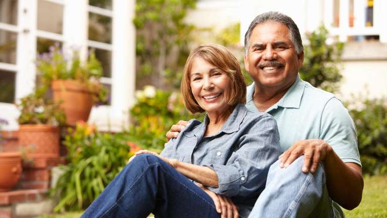 Older man and woman smiling after all-on-4 dental implants, huntsville al