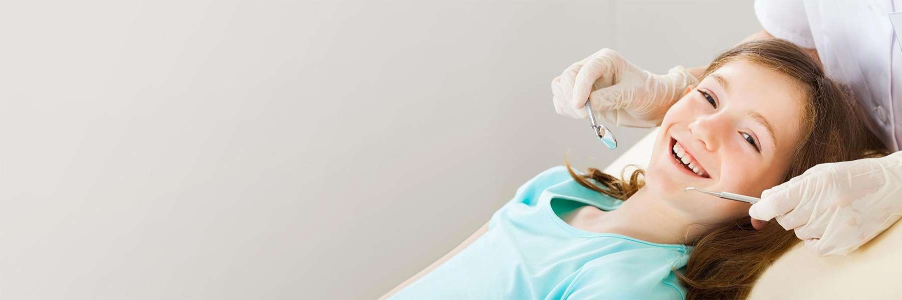 Smiling child getting a dental exam | Pediatric Dentistry Huntsville, AL